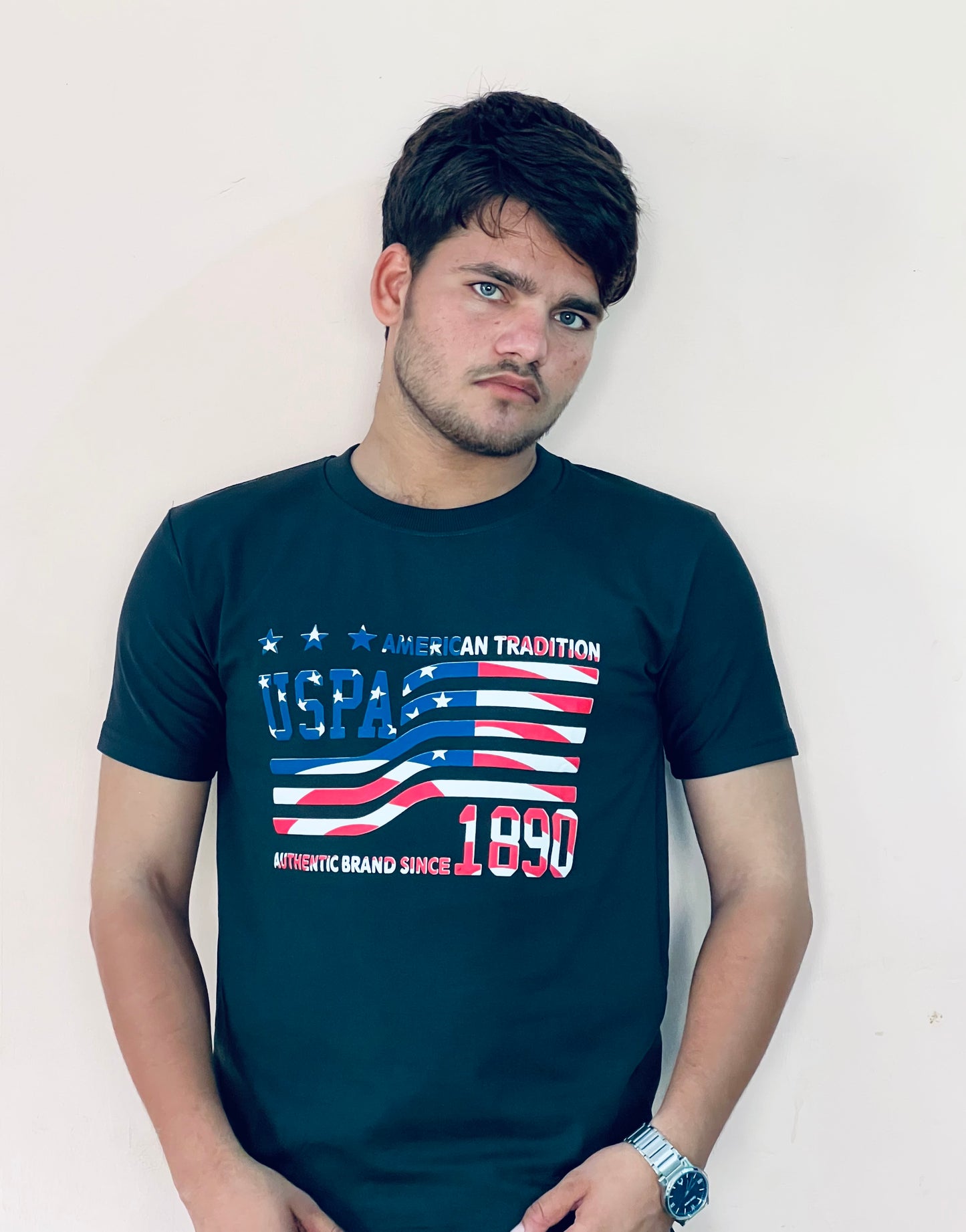 Man wearing navy blue US Polo Assn graphic t-shirt with American flag design and text print