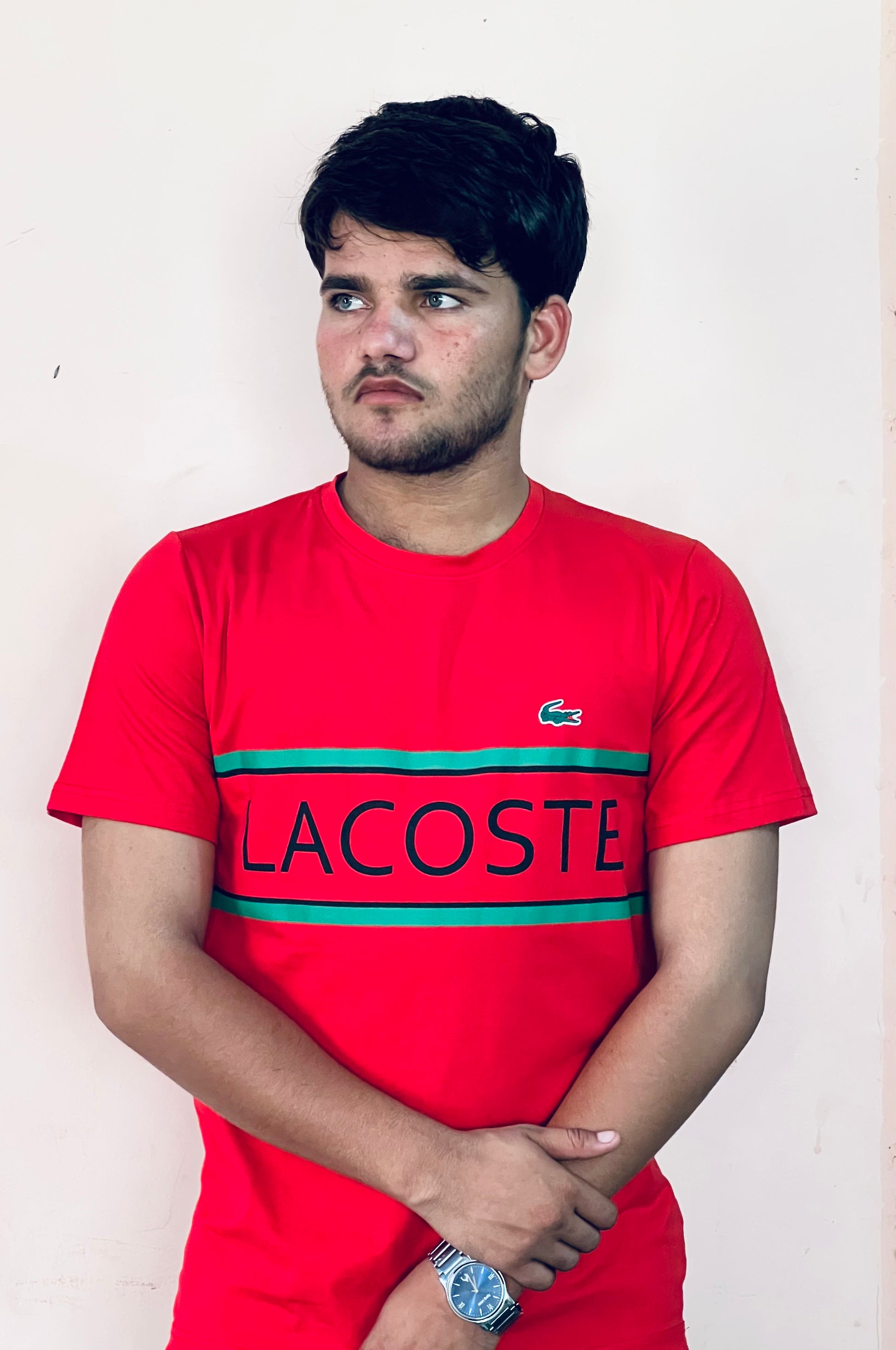 Man wearing Lacoste red slim fit t-shirt with logo and green stripes by Flaxwears