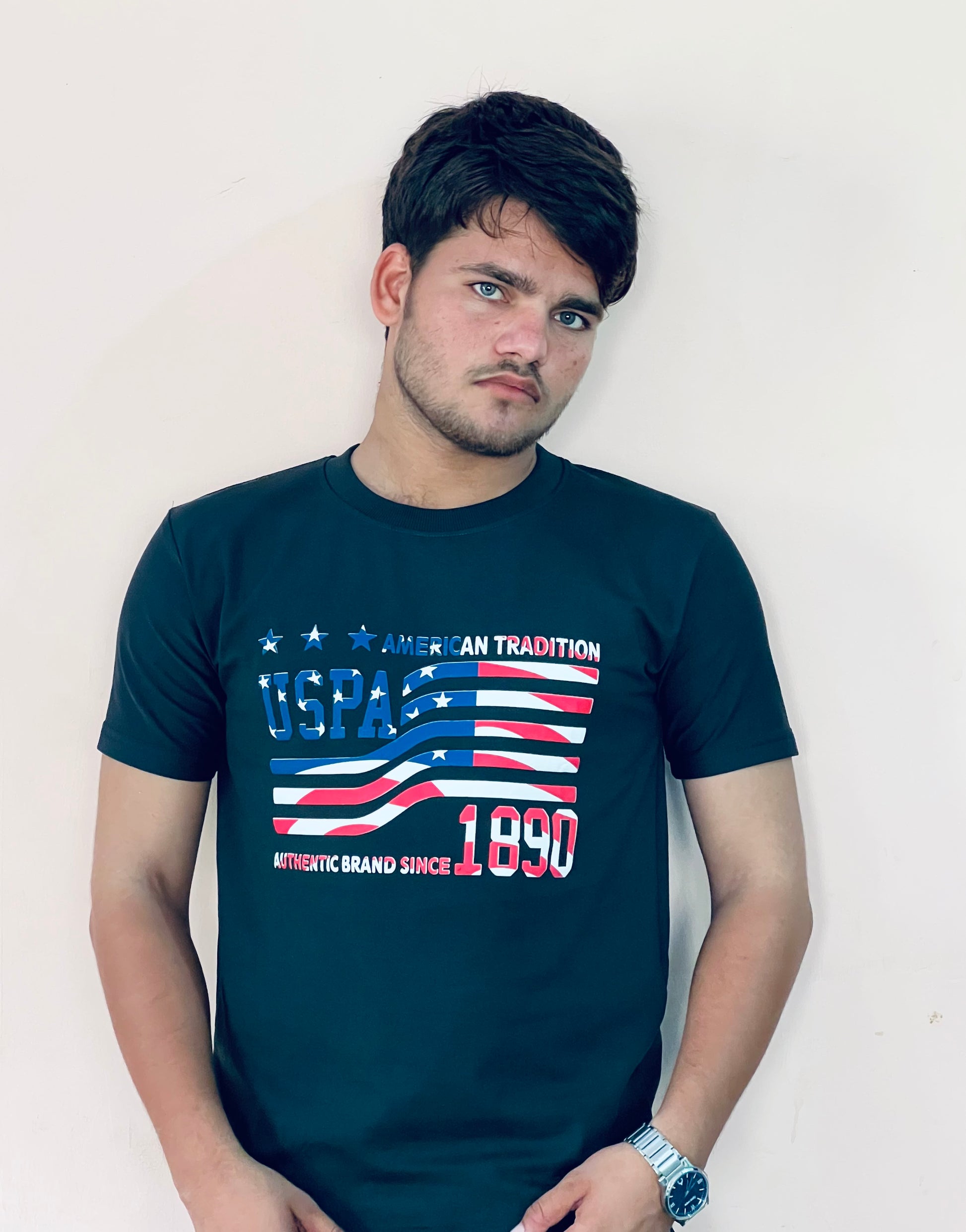 Man wearing navy blue US Polo Assn graphic t-shirt with American flag design and text print